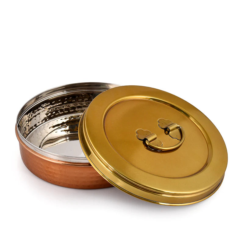 Copper and gold metal container with lid on a white background